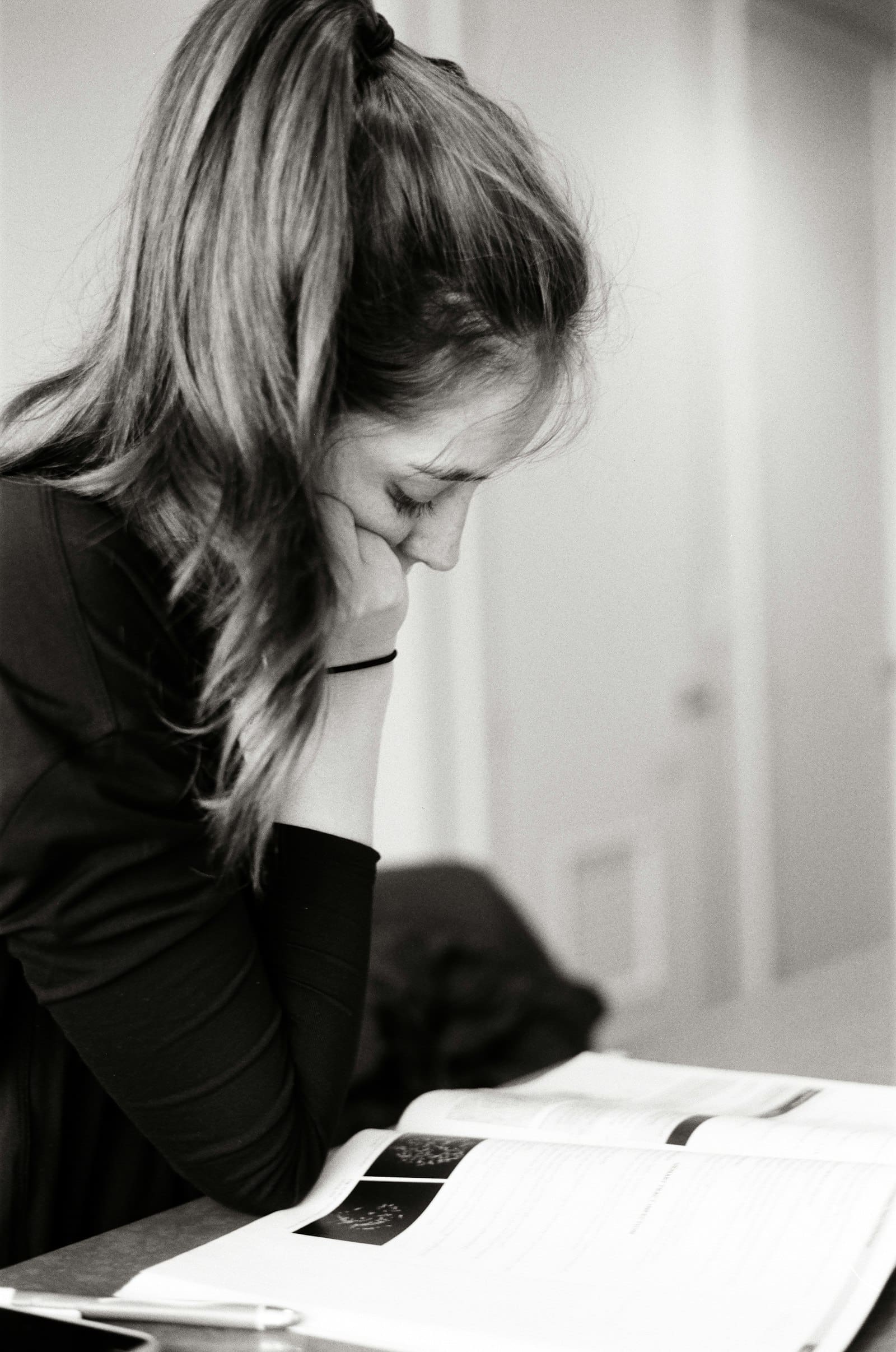 An adult returning to study, working calmly at a desk with books and notes